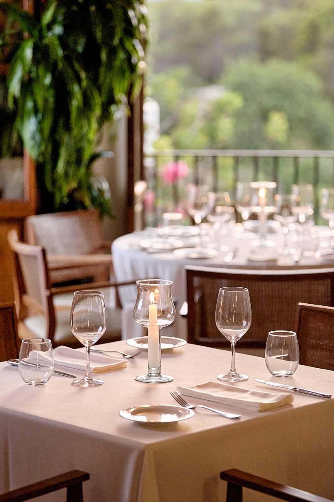 Candlelit table setting on the restaurant terrace at Can Curreu