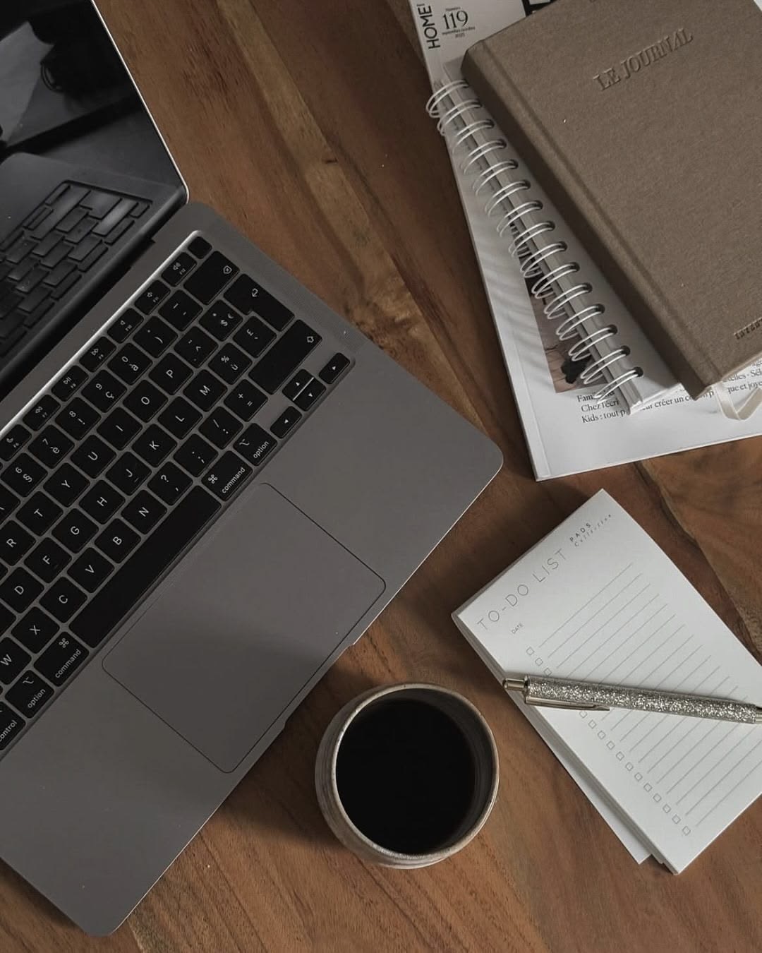 Laptop, coffee and a to-do list on a desk, planning the day